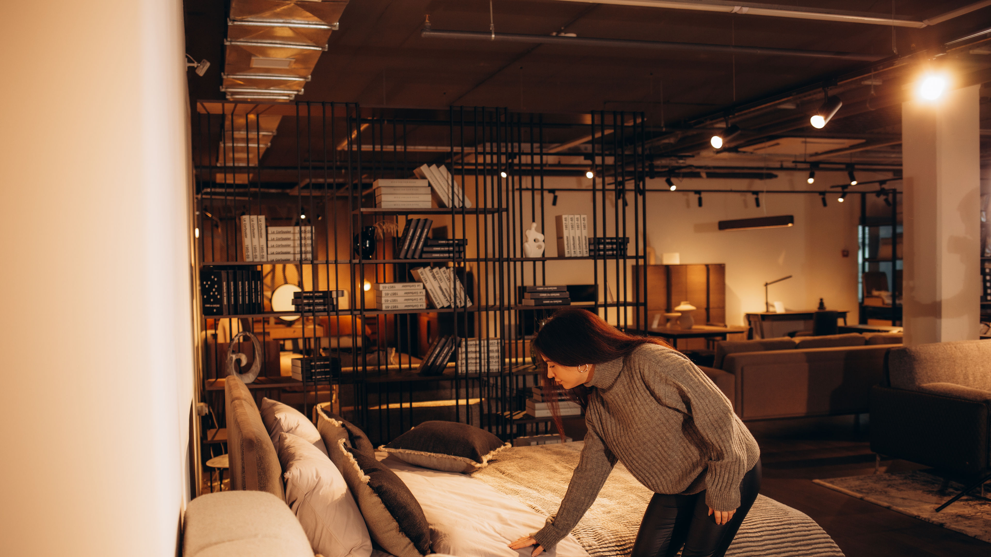 Happy woman smiling while looking to buy a new bedroom furniture at the showroom