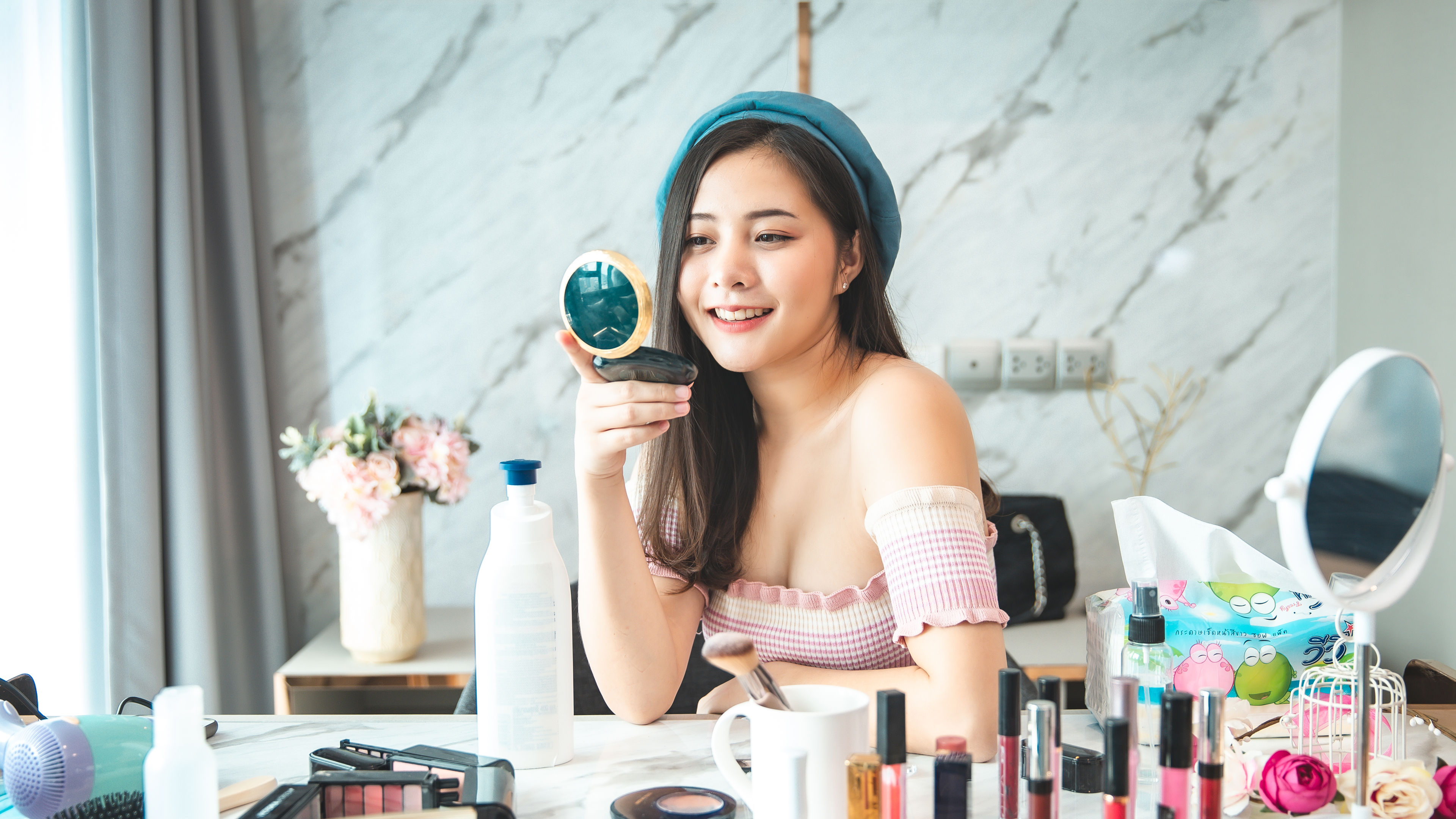 Portrait of young asian woman review cosmetics product