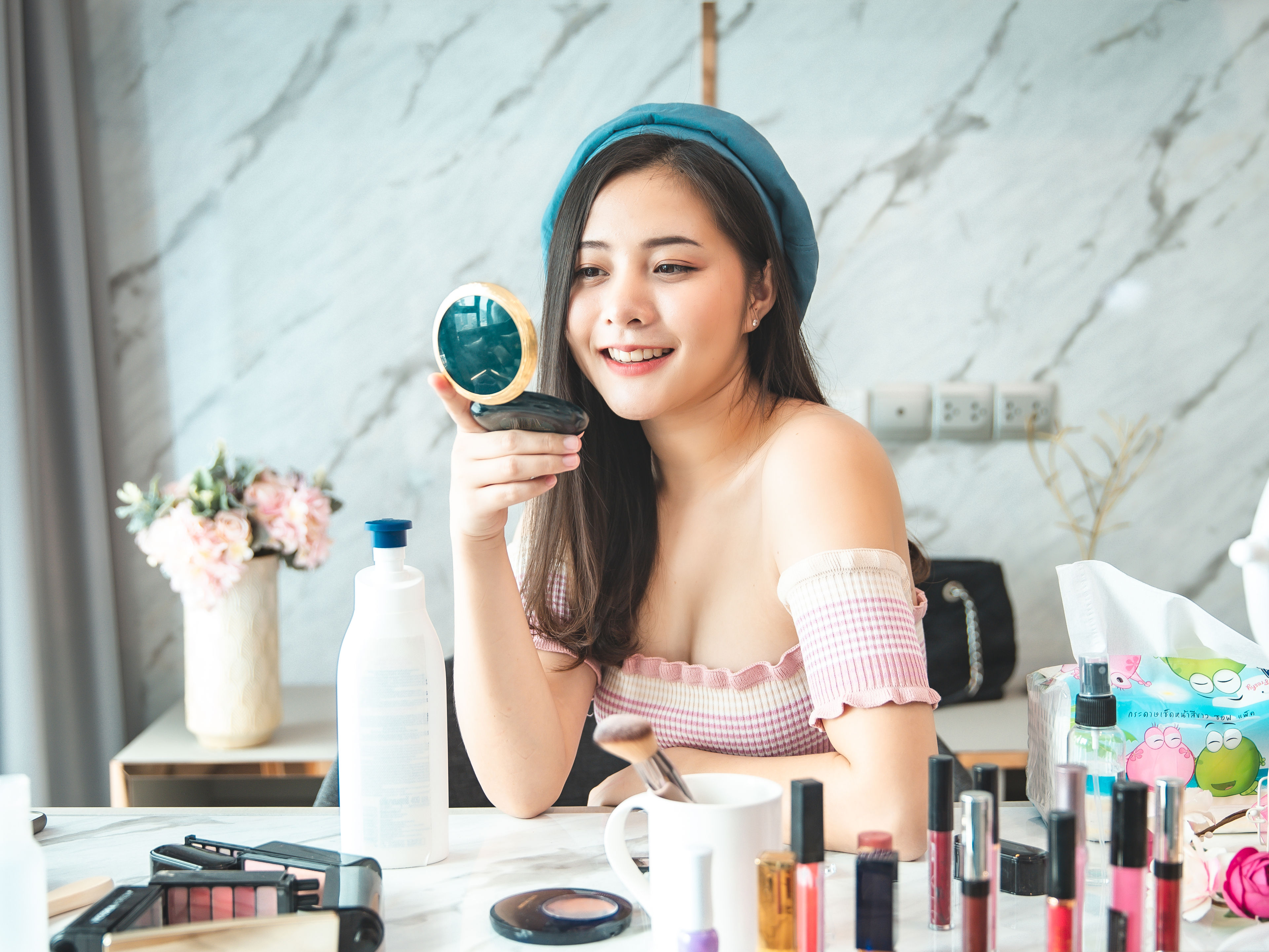 Portrait of young asian woman review cosmetics product